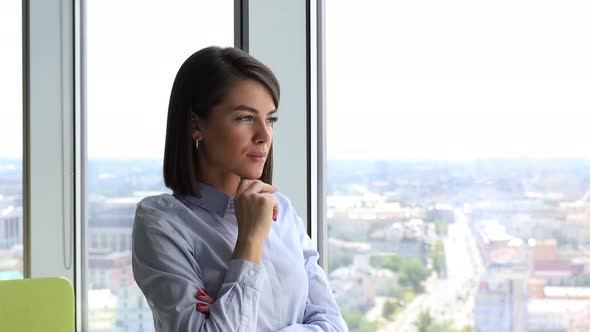 Happy Businesswoman Looking Through Window at Modern Office Enjoy Successful Day and Smiling