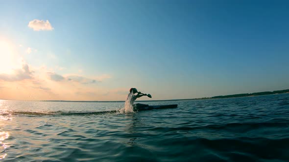 A Lake with a Male Boater Crossing It on a Canoe