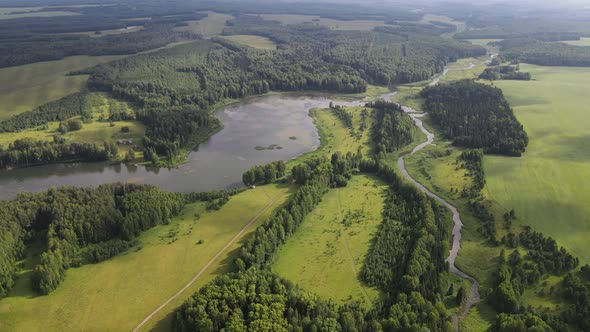 Landscape of River Flowing Through Green Forest and Fields