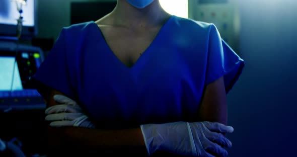 Portrait of female surgeon standing with arms crossed in operating room