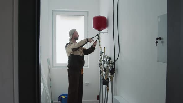 Plumber Fixing Water Heater Expansion Tank