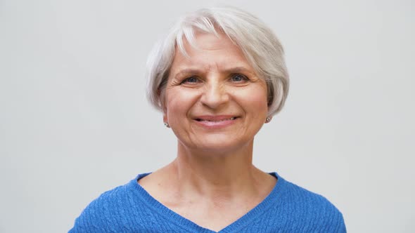 Portrait of Smiling Senior Woman Touching Her Hair 4