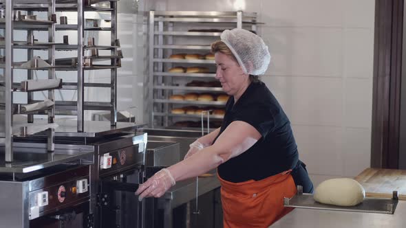 The Woman Chef Is Putting the Dough Into a Fridge