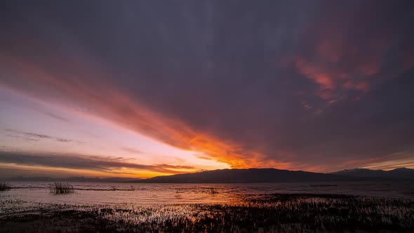 Time lapse looking over Utah Lake during colorful sunset over Lake Mountain