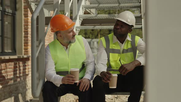 Architects Taking Coffee Break While Sitting at Working Area