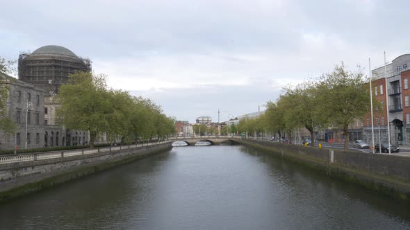 Calm Water Of Liffey River In City Centre Of Dublin In Ireland. - wide shot