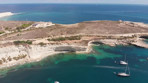 Aerial drone video from eastern Malta, Marsaxlokk area, Il-Hofra l-Kbira bay.