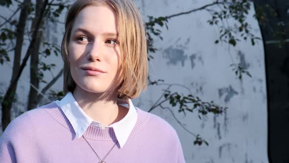 Portrait of Young Woman Student Near University Building