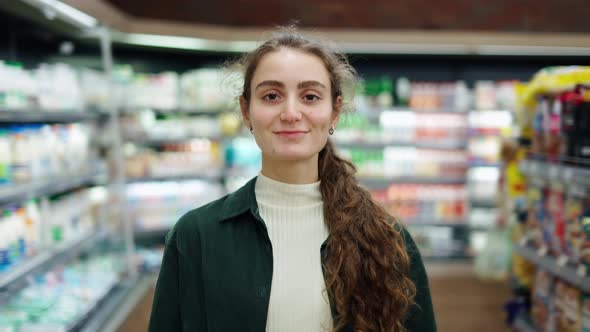 Portrait of the Young Beautiful Woman Smiling Happily to the Camera at the Grossery Supermarket