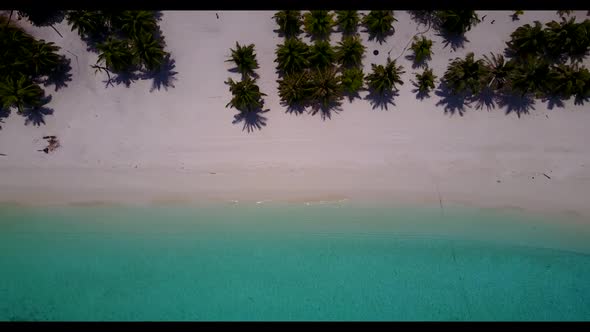 Aerial view scenery of tranquil shore beach vacation by blue ocean with white sandy background of a 