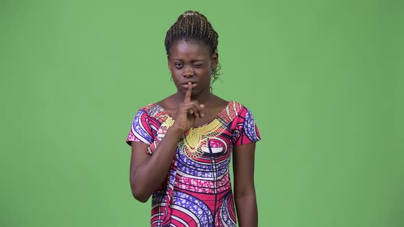 Young African Woman with Finger on Lips