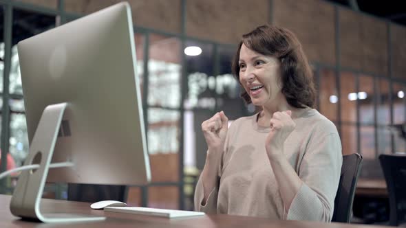 Excited Old Woman Celebrating Success at Work