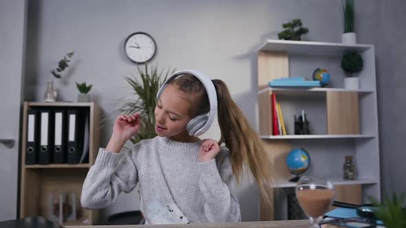 Joyful Teen Girl Doing Dancing Movements During Listening Cool Music in Headphones