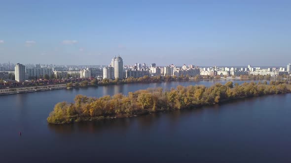 Aerial: Island on Dnipro river in Obolon district of Kiyv, autumn time