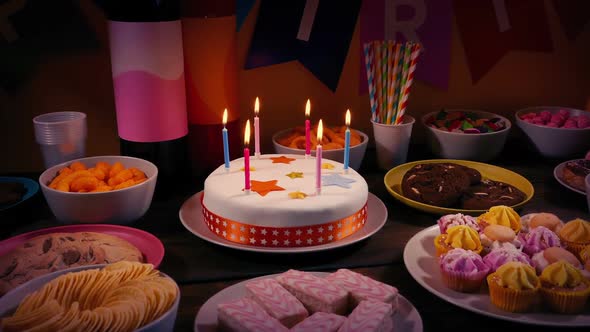 Birthday Celebration Table With Cake And Snacks