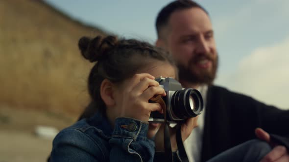 Small Kid Holding Camera Making Pictures of Sea Beach Landscape Family Trip