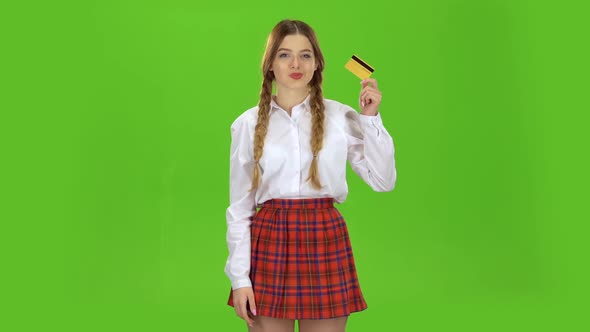 Student with a Credit Card in Her Hands Is Happy. Green Screen