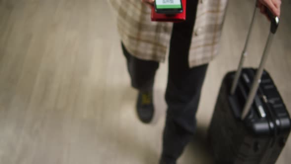 Tourist Showing QR Code on Phone in Airport Terminal