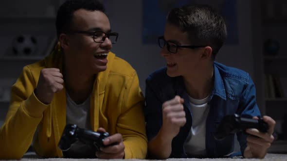 Multiracial Guys Winning Computer Game in Darkness, Risk of Losing Eyesight