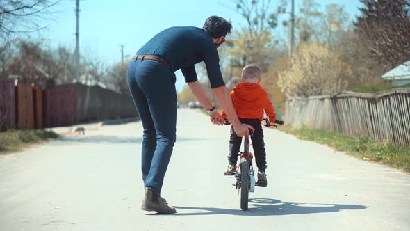 Cute Little Kid Having Fun. Carefree Dad With Preschool Son Cycling Enjoy Activity Adventure.