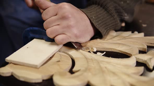 Carpenter Working on a Wooden in His Workshop on the Table Preparing a Detail of Wooden Product a