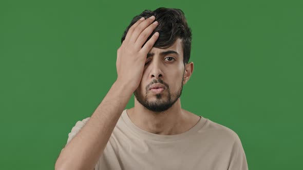 Male Portrait of Arabic Indian Disappointed Guy Upset Stressful Man Stand in Green Studio Cover Face