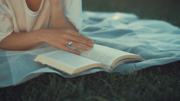 Young attractive girl is reading a book