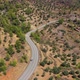 Car Drives on Winding Road Among Scrublands in Highland - VideoHive Item for Sale