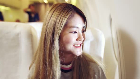 Happy Asian Woman Travel in Airplane