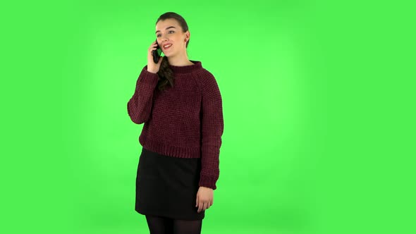 Smiling Girl Talking for Mobile Phone and Rejoice. Green Screen