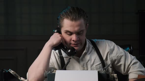 Detective or Gangster Sits at Table in Retro Interior and Talks on Phone