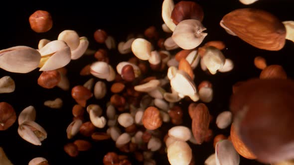 Super Slow Motion Closeup Shot of Falling Various Nuts Towards Camera on Black at 1000Fps