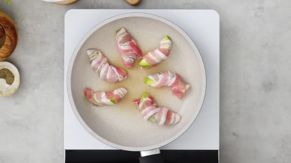 Crop anonymous cook preparing bacon avocado fries in kitchen