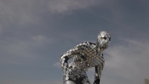 Sparkling Discosuit Man Dancing with Clouds Behind