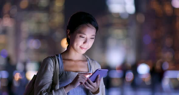 Woman Use of Mobile Phone for Mobile App at Night