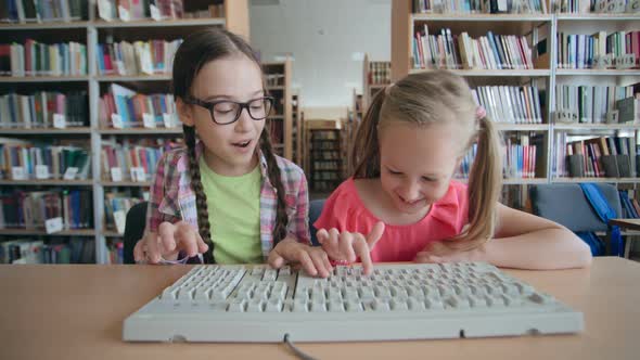 Cheerful Schoolgirls Typing  alt