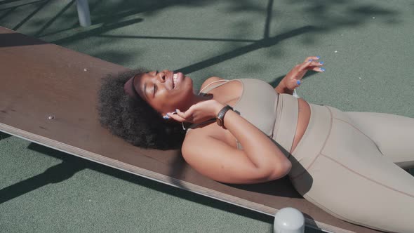 African American Sports Woman Enjoying Music in Earphones