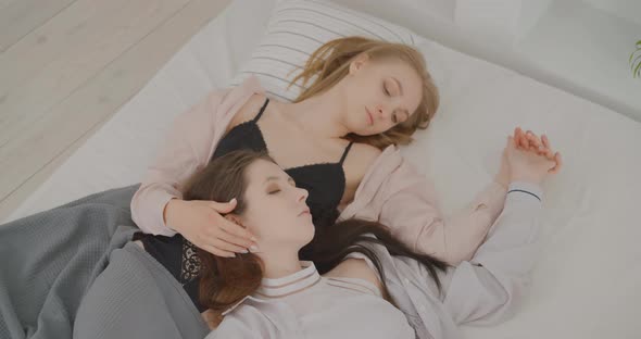 Lesbians are lying in bed Lesbians are talking in bed LGBT Bisexual Transgender Lesbian concept Love