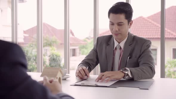 Smart handsome Businessmen signing a house contract