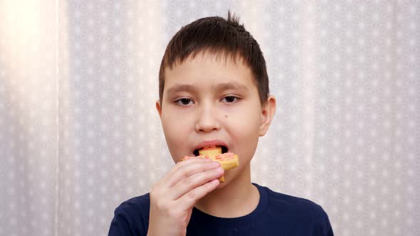 Closeup of a Boy Biting a Cookie