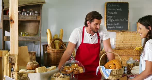 Woman purchasing bread at bakery store