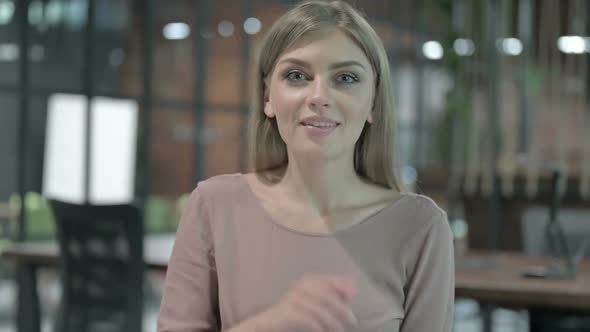 Portrait Shoot of Cheerful Woman Pointing with Finger