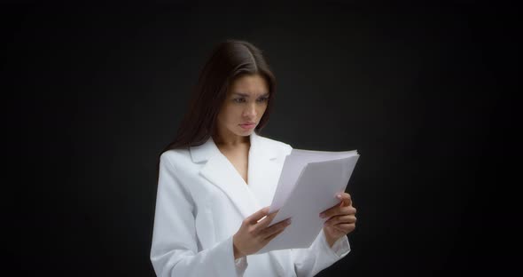 Businesswoman is Dissatisfied and Throws White Pieces of Paper