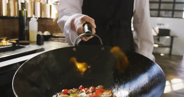 Chef cooking vegetables with fire