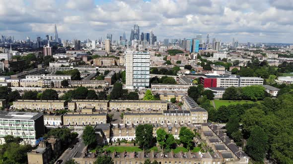 Aerial view of residential estates near a greed park with London skyline in the background