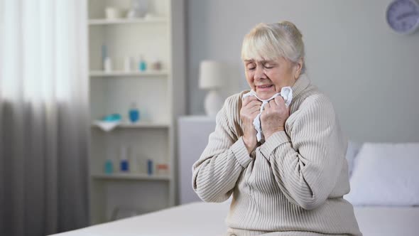 Unhappy Aged Lady Sitting Alone in Medical Center and Crying, Needs Treatment