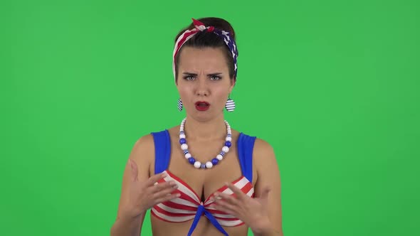 Portrait of Beautiful Girl in a Swimsuit Is Showing Disgust for Bad Smell or Taste. Green Screen