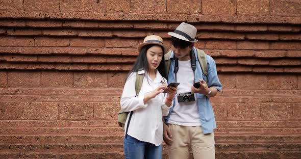Couple checks location on smartphone online map