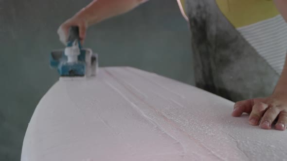 Male surfboard maker in his workshop