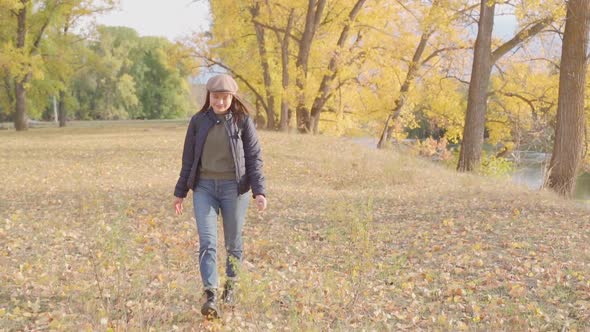 Girl Tourist on a Hike in the Autumn Forest